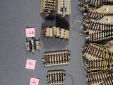 many different types of train tracks and wires on the table