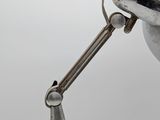 a close up of a person using a pair of pliers to fix a lamp