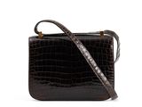 the small square bag is made of alligator skin and has a metal handle