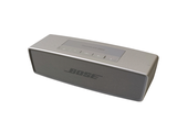 a silver speaker that is sitting on top of a table