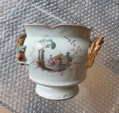 a vase with a handle that has a painting on it