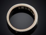 a close up of a silver ring on a black surface