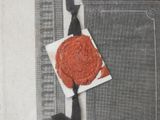a man holding a piece of paper with a wax seal on it