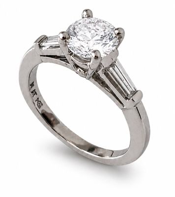 a close up of a diamond ring on a white background