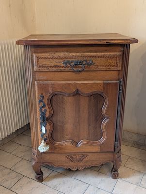 a small wooden cabinet with a drawer on top of it