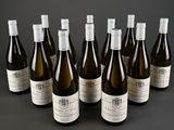 six bottles of wine are lined up in a row on a table
