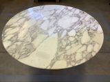 a marble table with a white top in a room