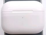 a white apple airpods case sitting on top of a cell phone
