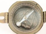 an image of a close up of a compass on a white surface