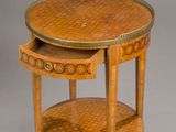 an image of a round table with a drawer underneath it