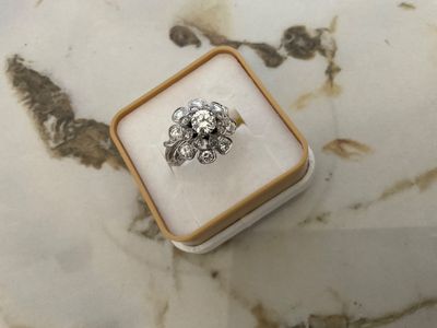 a close up of a ring sitting on top of a marble table