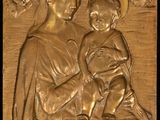 a close up of a plaque of a woman holding a baby
