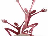sculpture of a group of people holding hands up in the air