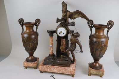 three vases and a clock sitting on a table