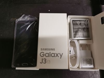 a box with a phone inside of it on a table
