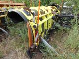 a yellow tractor that is sitting in the grass