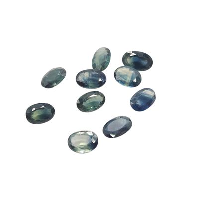 a group of blue and green gems on a white surface
