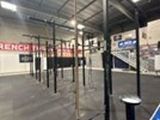 a gym area with a blue floor and white walls