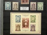 an old picture of a collection of stamps on display in a glass case