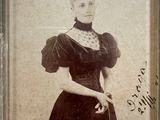 an old photo of a woman in a black dress