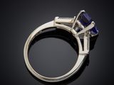 a blue sapphire and diamond ring on a black background