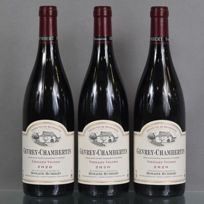 three bottles of red wine are lined up on a table