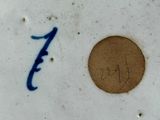 a picture of a plate with a blue number on it