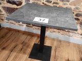 a small table with a number on it in front of a stone wall