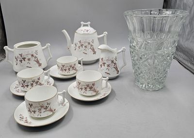a lot of cups and saucers sitting on a table