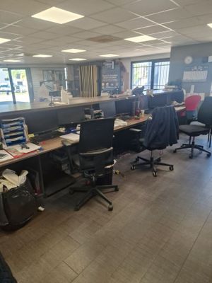 a room with a lot of desks and chairs in it