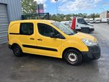 the yellow van is parked in front of a building