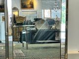 a large mirror sitting on the floor in a living room