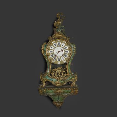 a clock that is hanging on the wall with a bird on it