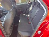 the back seats of a red car with the door open
