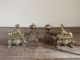 three brass candlesticks sitting on a wooden table