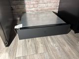 a metal drawer that is open on the floor