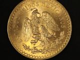 a close up of a gold coin on a black surface