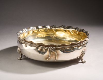 an image of a silver bowl on a stand on a white surface