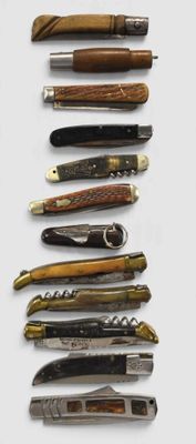 several different types of knives are lined up on a white surface