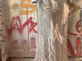 a mannequin in a room with graffiti on the walls