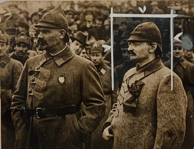 an old photo of two men in uniform standing in front of a crowd