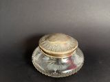 an image of a small glass jar with a lid on a table