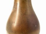 a brown vase that is sitting on a white surface