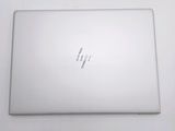 the back of a white laptop computer sitting on top of a white table