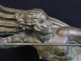 a statue of an angel holding a bow and arrow
