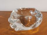 a clear glass candle holder on a wooden table