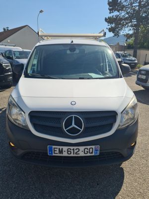 the white van is parked in a parking lot with other cars