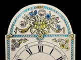 a clock that has a floral design on it