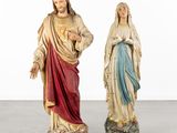 two statues of jesus and mary on a white background