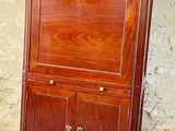 a wooden cabinet with a drawer on top of it
